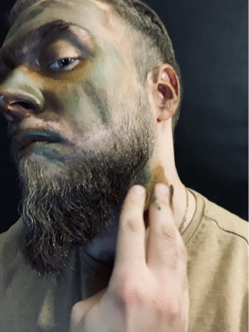 a man applying ASG camouflage to his neck